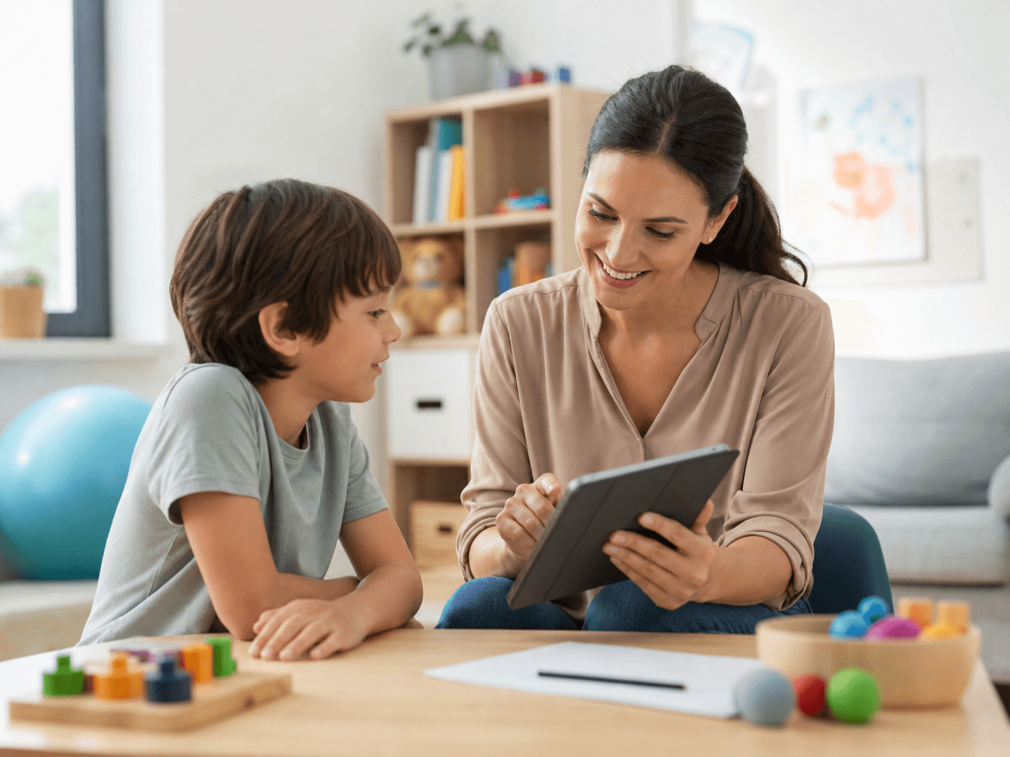 Therapist sitting with a young client during a calm therapy conversation